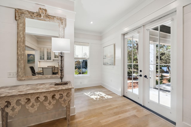 254 E Yacht Pond Ln, Watersound, FL 32461 - doorway to outside with baseboards, light wood-style floors, french doors, and a healthy amount of sunlight