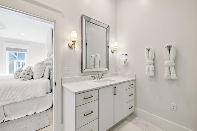 254 E Yacht Pond Ln, Watersound, FL 32461 - bathroom with marble finish floor, vanity, baseboards, and ensuite bath