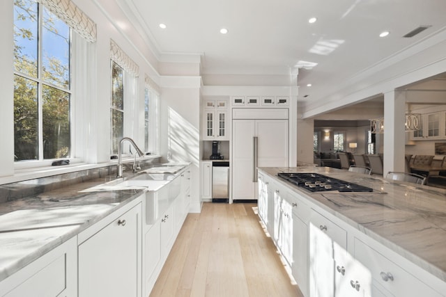 254 E Yacht Pond Ln, Watersound, FL 32461 - kitchen with stainless steel gas stovetop, dishwasher, ornamental molding, paneled built in fridge, and light stone counters