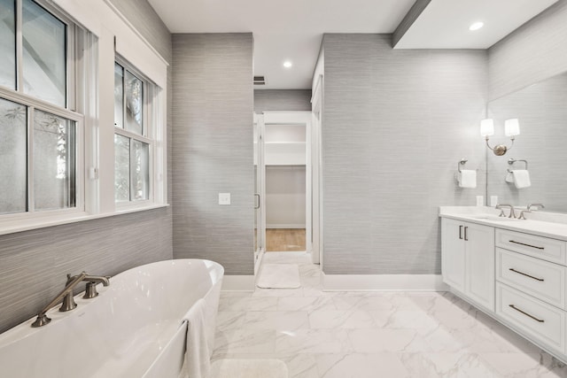 254 E Yacht Pond Ln, Watersound, FL 32461 - bathroom featuring a soaking tub, baseboards, marble finish floor, recessed lighting, and vanity