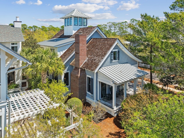 254 E Yacht Pond Ln, Watersound, FL 32461 - back of property with a chimney, a standing seam roof, and metal roof