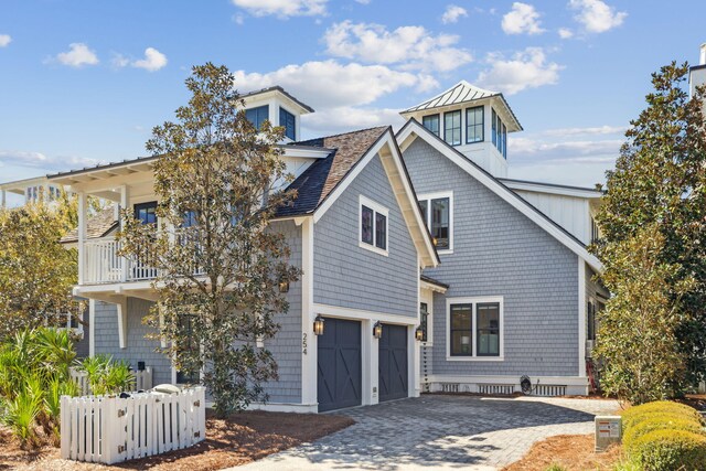 254 E Yacht Pond Ln, Watersound, FL 32461 - view of front facade featuring a balcony, decorative driveway, a garage, and roof with shingles