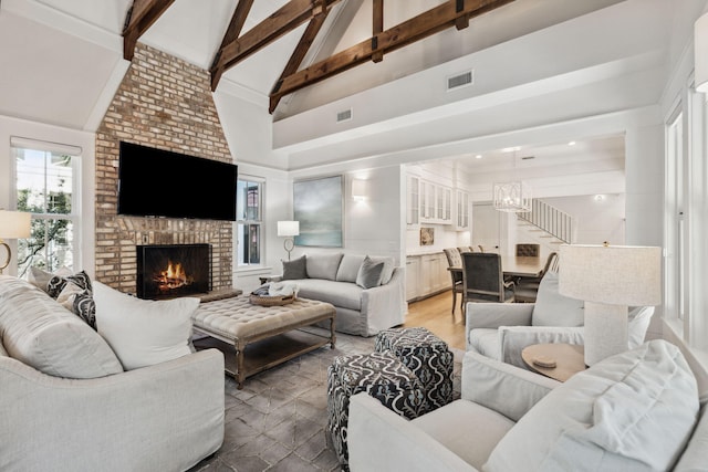254 E Yacht Pond Ln, Watersound, FL 32461 - living room with a fireplace, beam ceiling, a chandelier, and visible vents