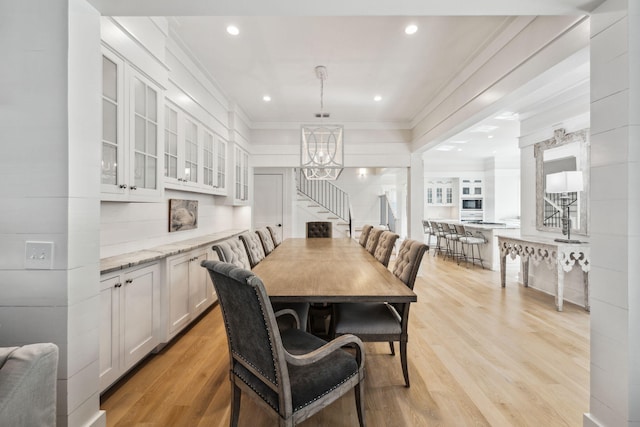 254 E Yacht Pond Ln, Watersound, FL 32461 - dining area with an inviting chandelier, ornamental molding, light wood-style floors, and stairs