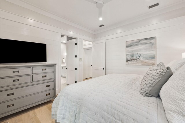 254 E Yacht Pond Ln, Watersound, FL 32461 - bedroom with light wood-type flooring, ornamental molding, ensuite bath, and visible vents