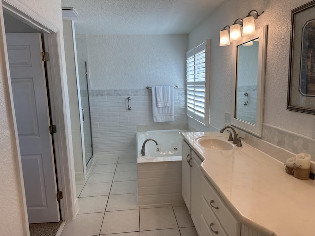 full bathroom featuring a shower stall, a whirlpool tub, a textured wall, tile patterned floors, and a textured ceiling