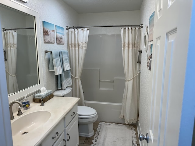 full bathroom featuring vanity, shower / bath combo, tile patterned flooring, toilet, and a textured wall