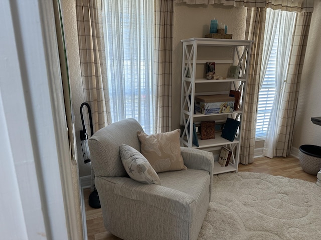 living area featuring wood finished floors and baseboards