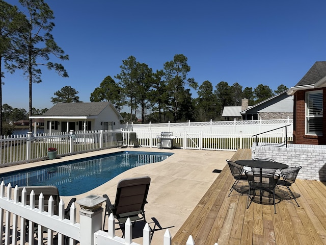 view of pool featuring a patio area, a fenced in pool, and fence