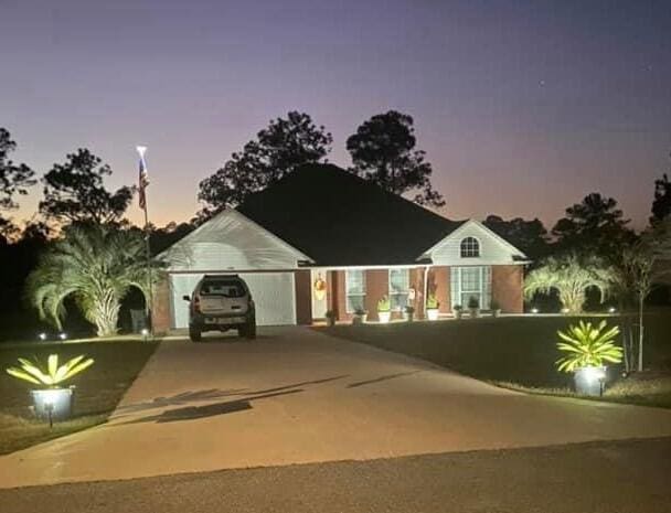 ranch-style home featuring concrete driveway