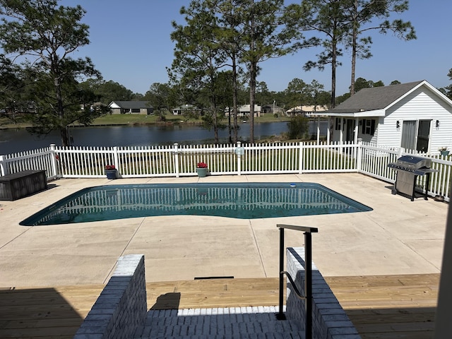 view of swimming pool with a fenced in pool, fence, a water view, grilling area, and a patio area