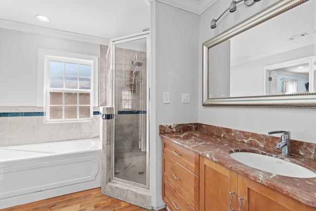 full bath with ornamental molding, a stall shower, a garden tub, and vanity