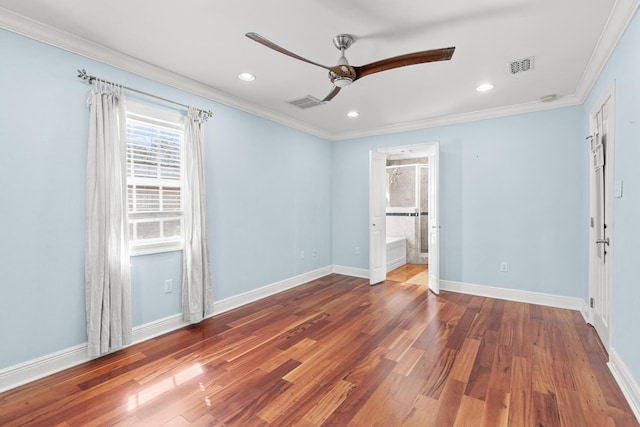 unfurnished bedroom featuring visible vents, crown molding, baseboards, and wood finished floors