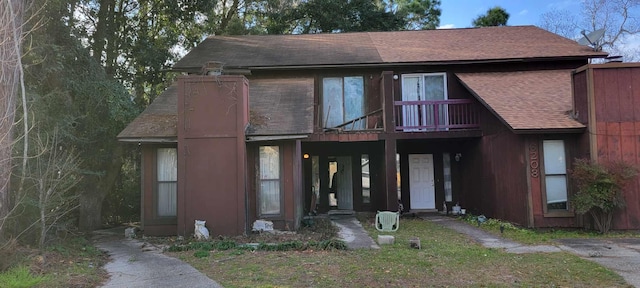 view of front of property with roof with shingles and a wooden deck