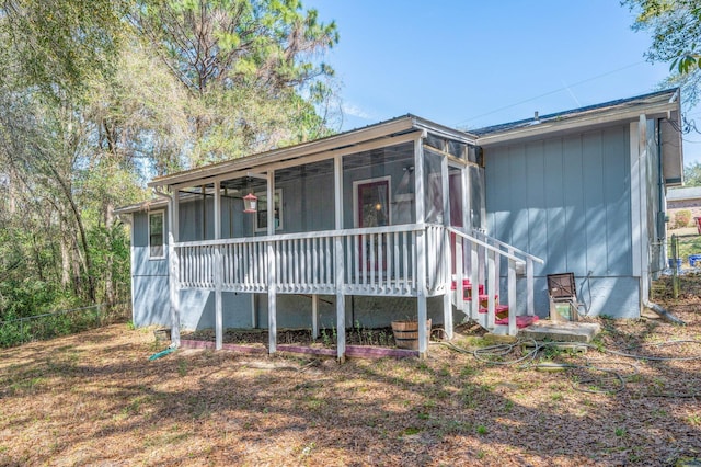 view of front of house featuring a sunroom and fence