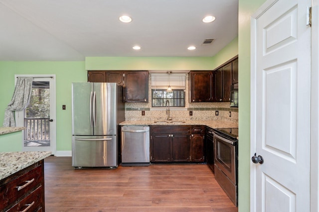 kitchen featuring a wealth of natural light, visible vents, appliances with stainless steel finishes, and a sink