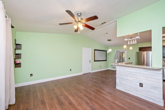 unfurnished living room featuring dark wood finished floors, visible vents, vaulted ceiling, ceiling fan, and baseboards