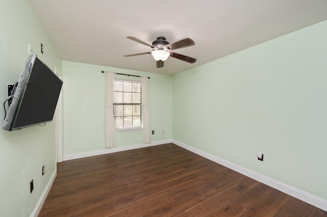 interior space featuring ceiling fan, dark wood finished floors, and baseboards