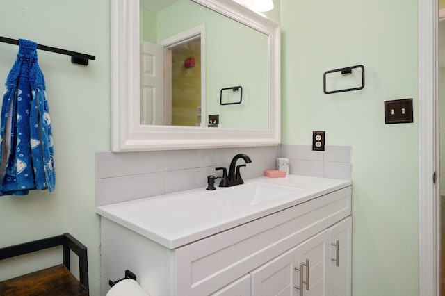 bathroom with tasteful backsplash and vanity