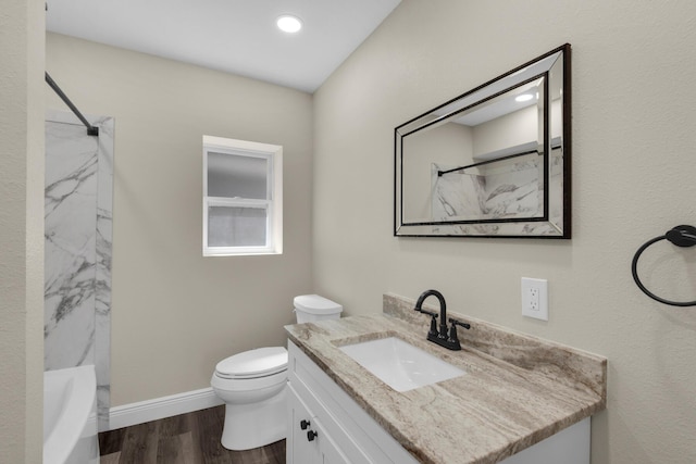 bathroom featuring vanity, wood finished floors, toilet, and baseboards