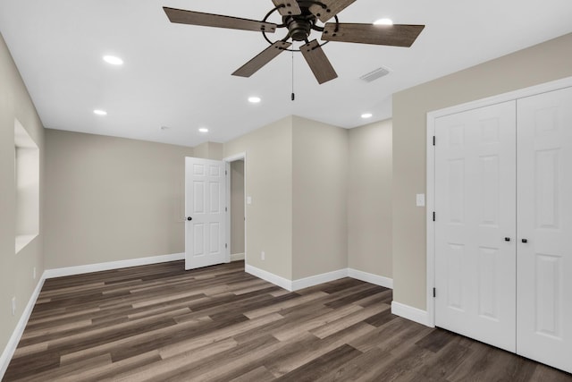 empty room with recessed lighting, wood finished floors, visible vents, and baseboards