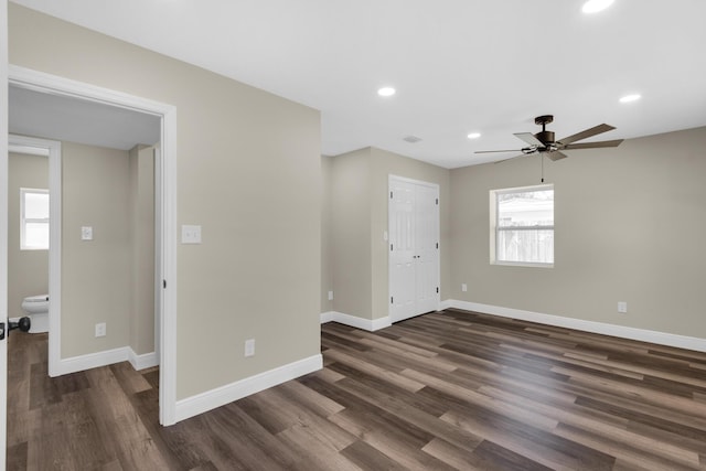 spare room featuring visible vents, baseboards, dark wood finished floors, and recessed lighting