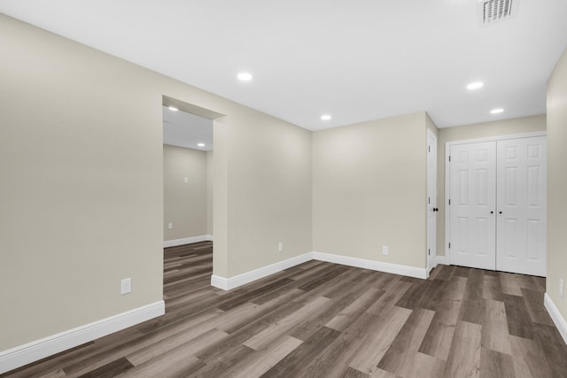 interior space with baseboards, visible vents, dark wood-style flooring, and recessed lighting