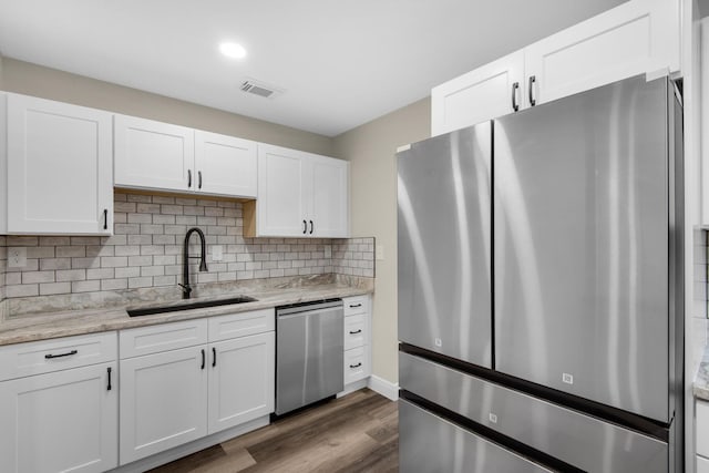 kitchen with white cabinetry, stainless steel appliances, and a sink