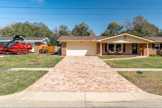 single story home with a front yard, fence, a garage, decorative driveway, and brick siding