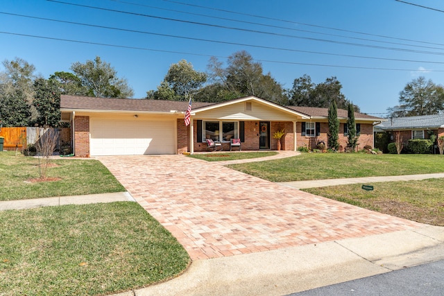 ranch-style house featuring a front lawn, decorative driveway, fence, a garage, and brick siding