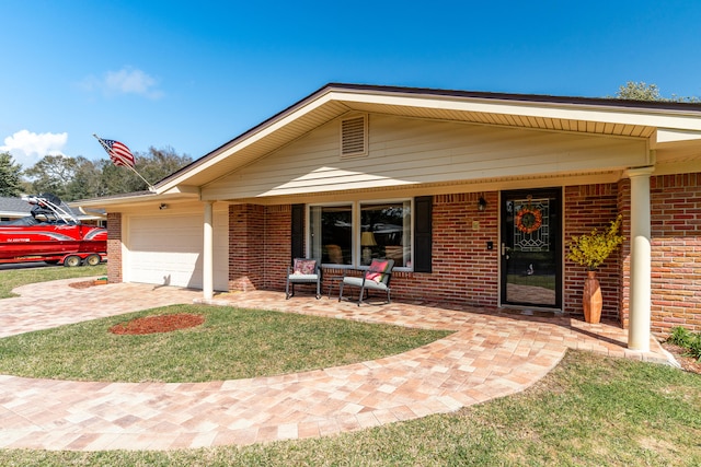 ranch-style house featuring brick siding, a porch, driveway, and a garage