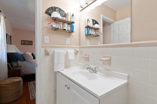 bathroom with vanity, tile walls, and wainscoting