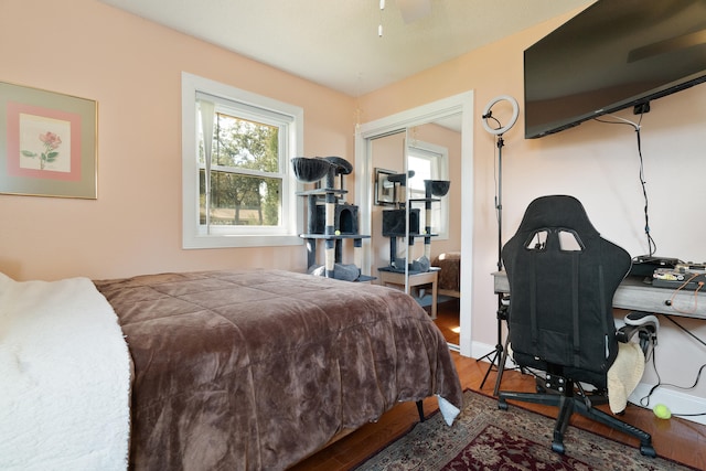 bedroom featuring wood finished floors and baseboards