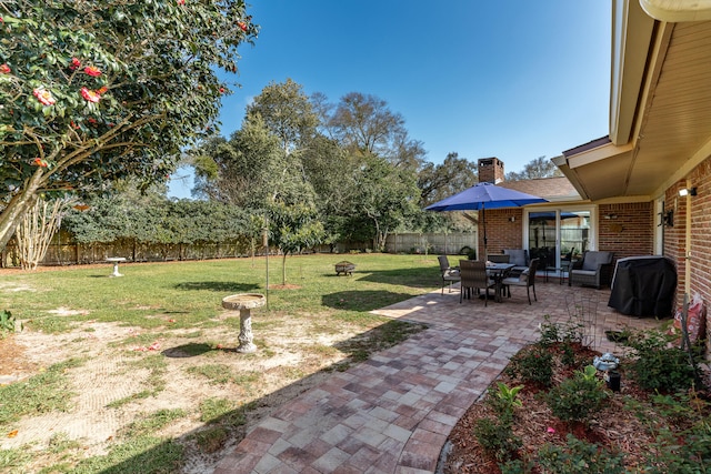 view of yard with a patio and a fenced backyard