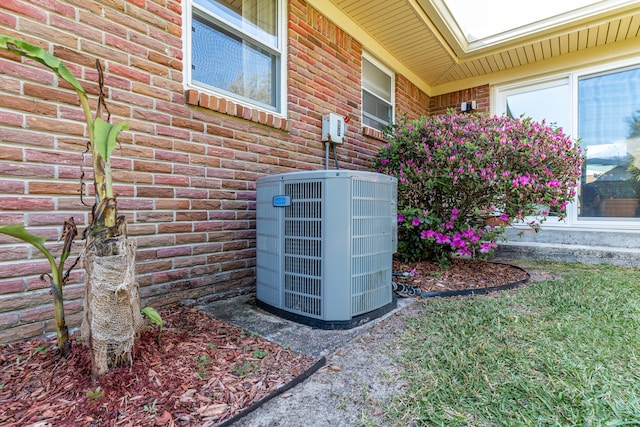 exterior details with brick siding and central AC