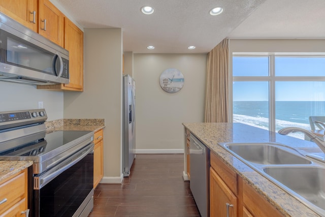 kitchen featuring a healthy amount of sunlight, stainless steel appliances, a sink, and recessed lighting