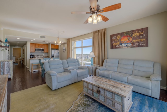 living room with recessed lighting, dark wood-style flooring, visible vents, and ceiling fan with notable chandelier