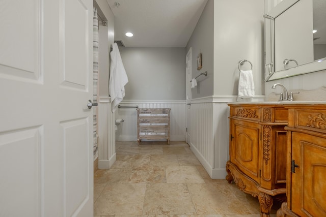 bathroom with wainscoting and vanity