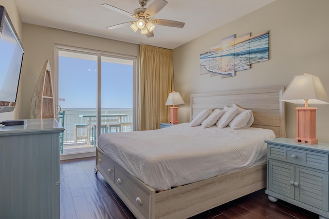 bedroom with dark wood-style flooring, a ceiling fan, and access to exterior