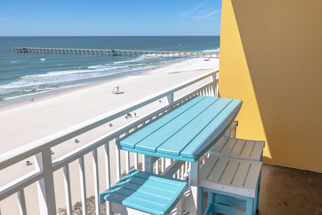 balcony with a view of the beach and a water view