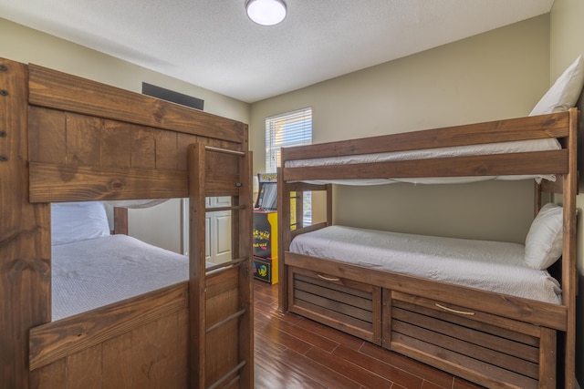 bedroom featuring dark wood-style flooring