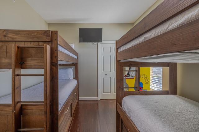 bedroom featuring baseboards and dark wood finished floors