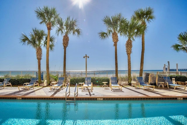 pool with a water view and a patio