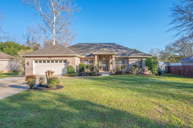 ranch-style house featuring driveway, fence, a front yard, an attached garage, and brick siding