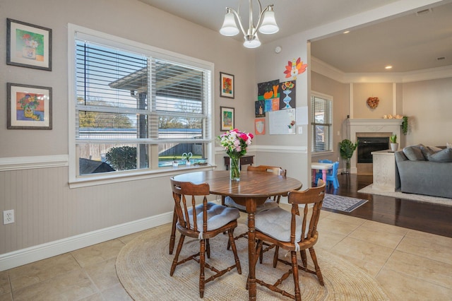 dining space featuring a wealth of natural light, a fireplace, and tile patterned floors