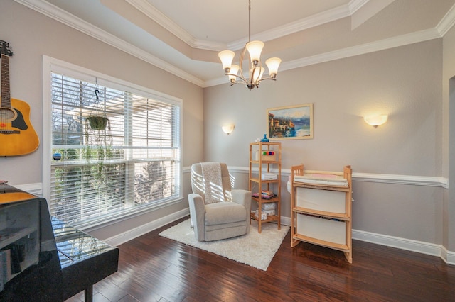 living area featuring wood finished floors, baseboards, a tray ceiling, ornamental molding, and a chandelier