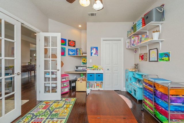 rec room with visible vents, french doors, ceiling fan, and wood finished floors