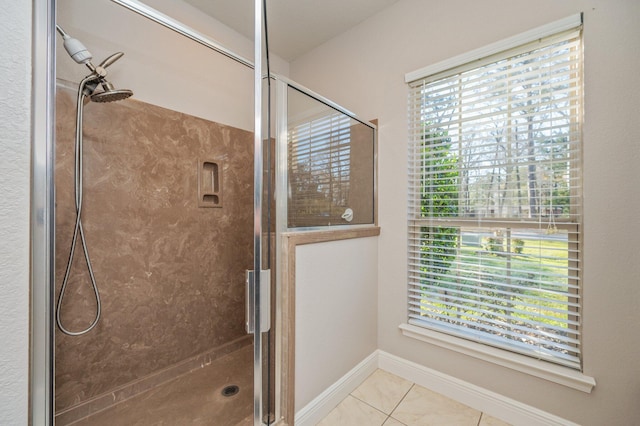 full bathroom with baseboards, a shower stall, and tile patterned flooring