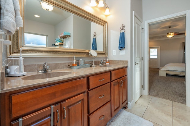 ensuite bathroom with a sink, connected bathroom, double vanity, and tile patterned flooring