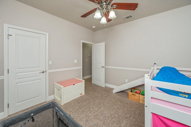 carpeted bedroom featuring a ceiling fan, baseboards, and visible vents